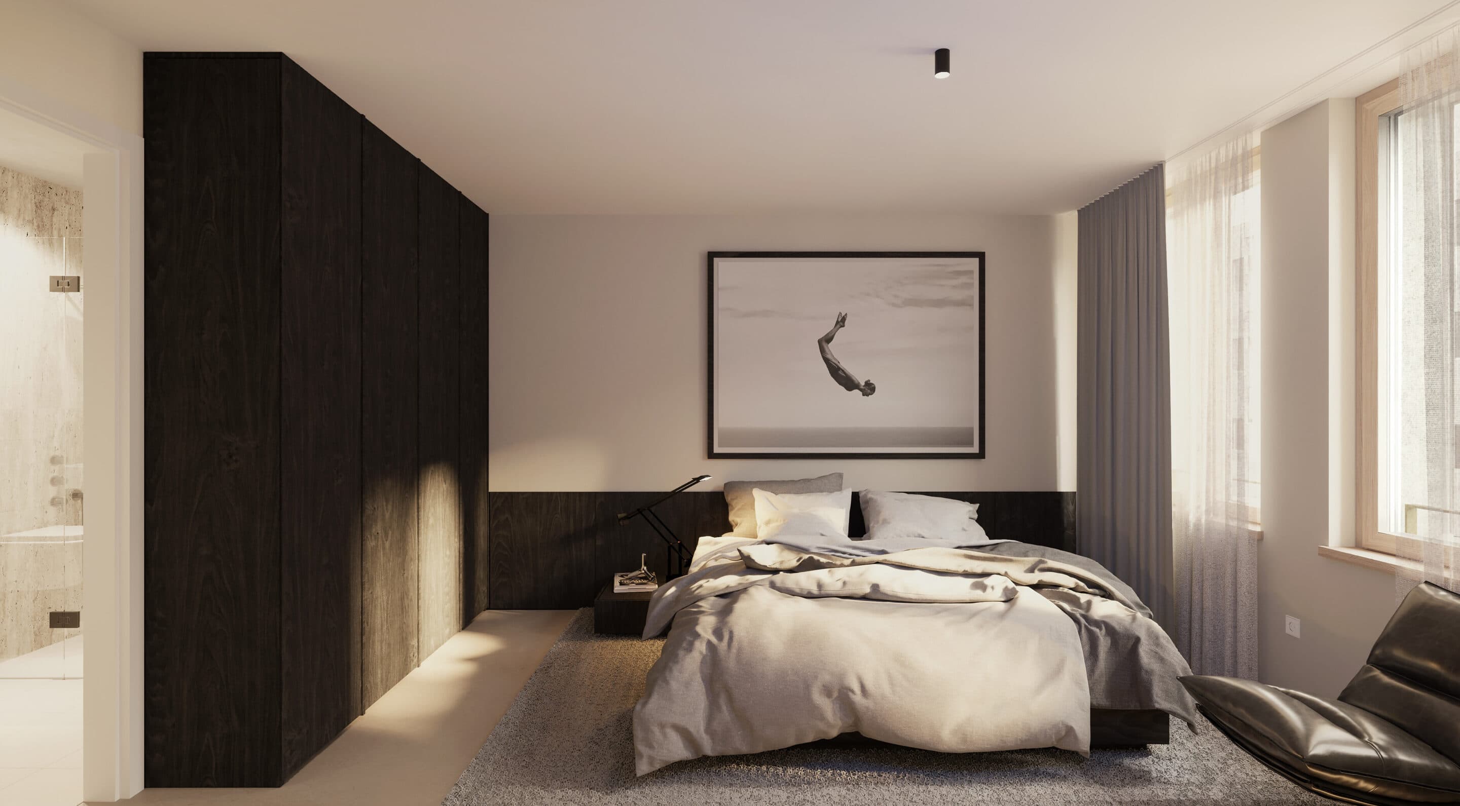 Schlafzimmer mit Blick auf den Essbereich, im Vordergrund ein Sessel